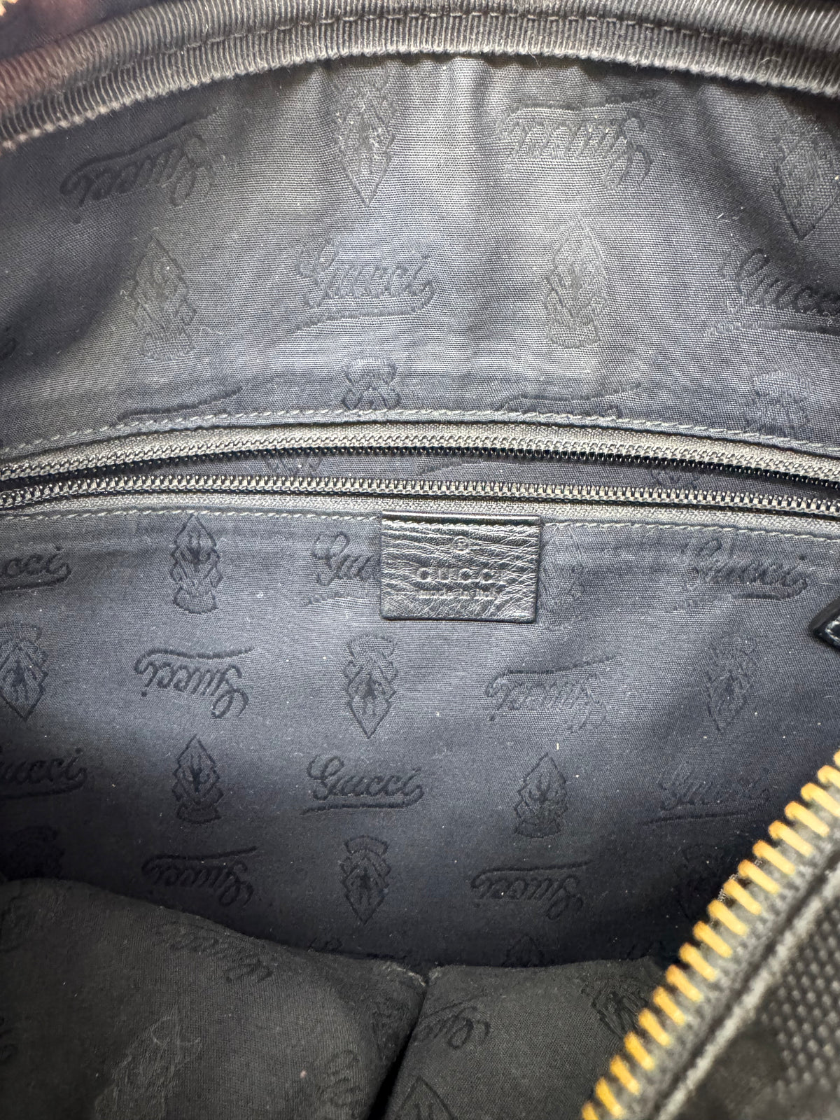 Gucci GG Imprime messenger bag in black, featuring a coated canvas body with tonal monogram detailing and adjustable strap