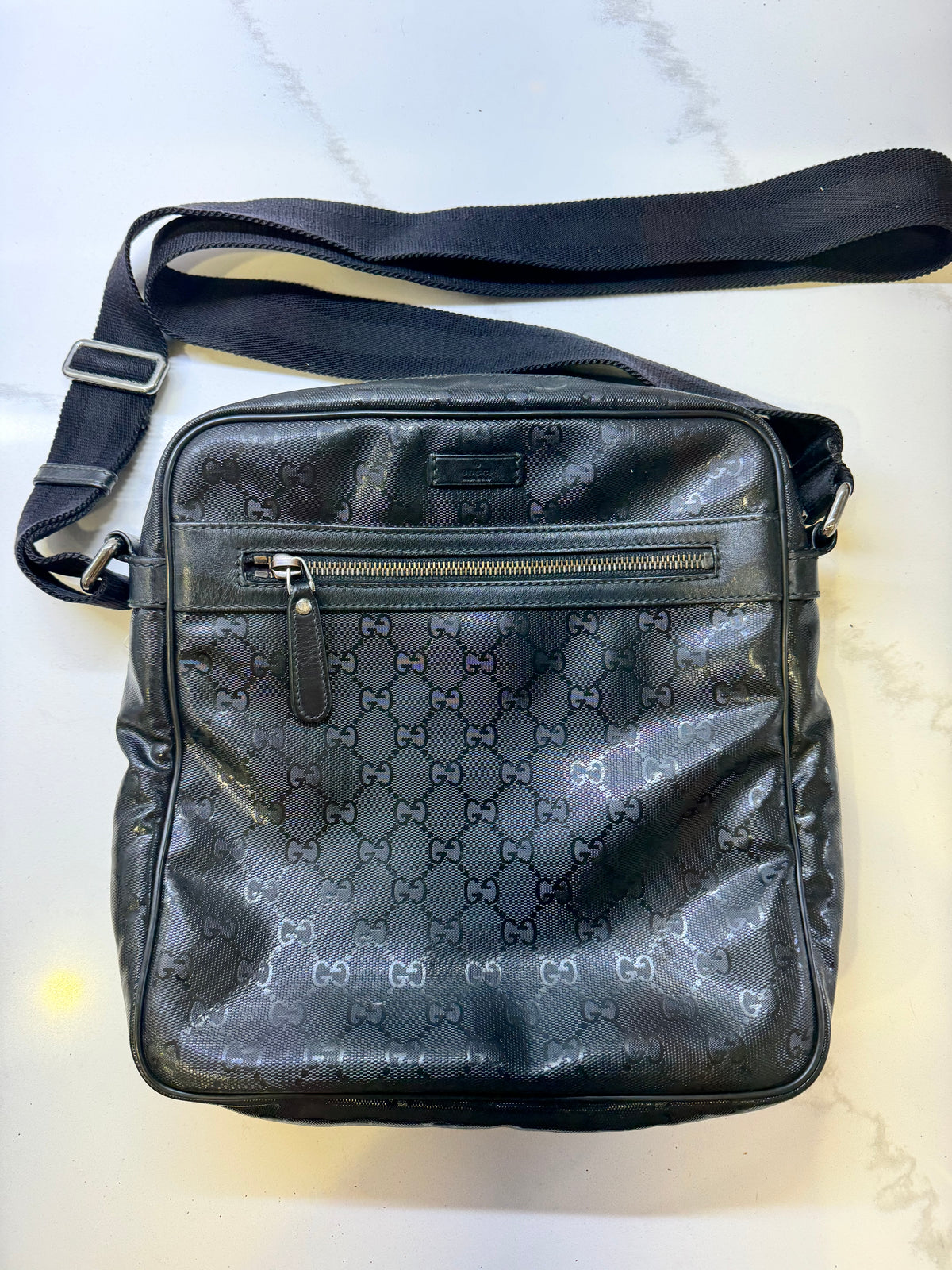 Gucci GG Imprime messenger bag in black, featuring a coated canvas body with tonal monogram detailing and adjustable strap