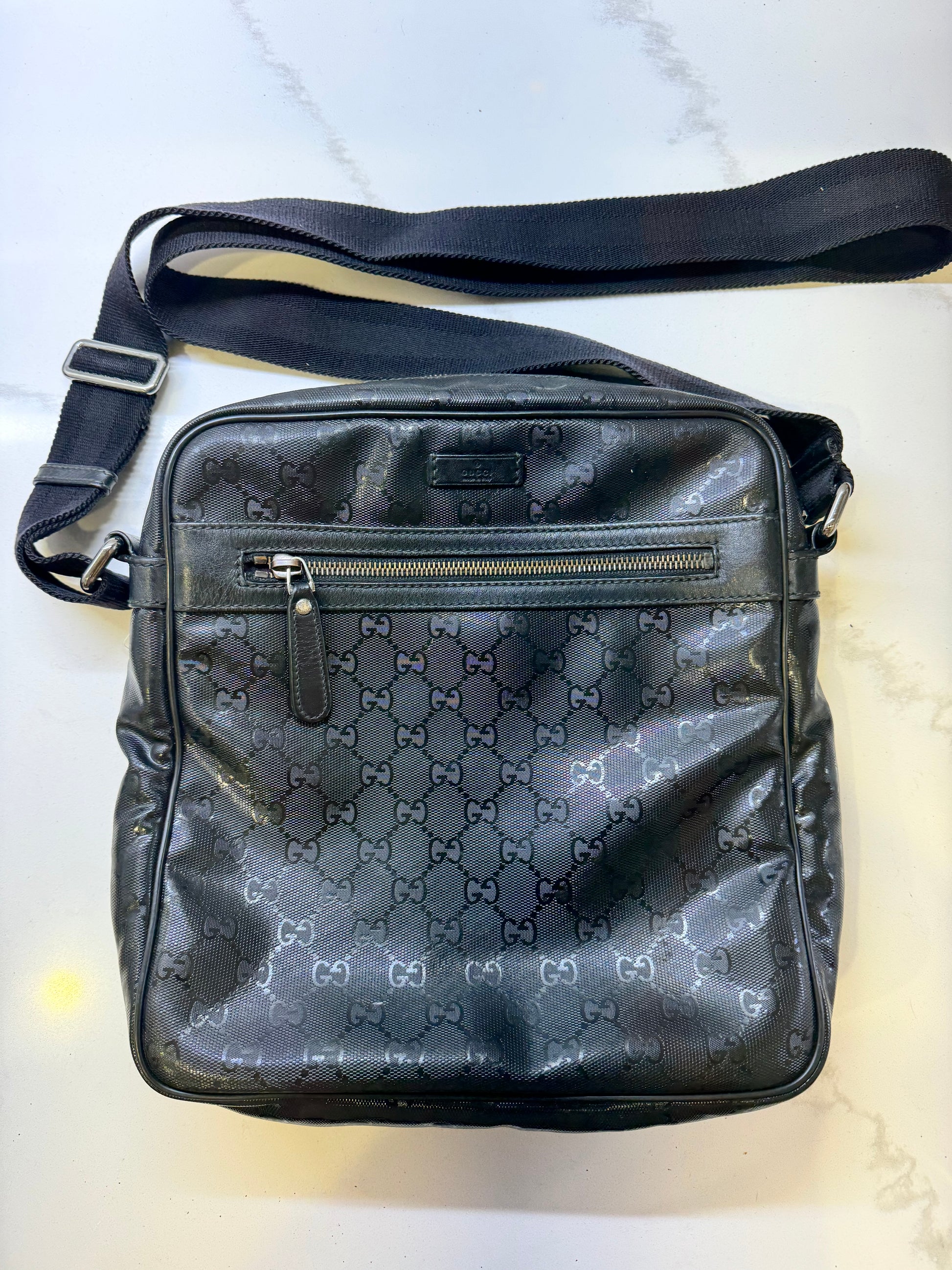 Gucci GG Imprime messenger bag in black, featuring a coated canvas body with tonal monogram detailing and adjustable strap