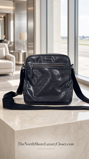 Gucci GG Imprime messenger bag in black, featuring a coated canvas body with tonal monogram detailing and adjustable strap